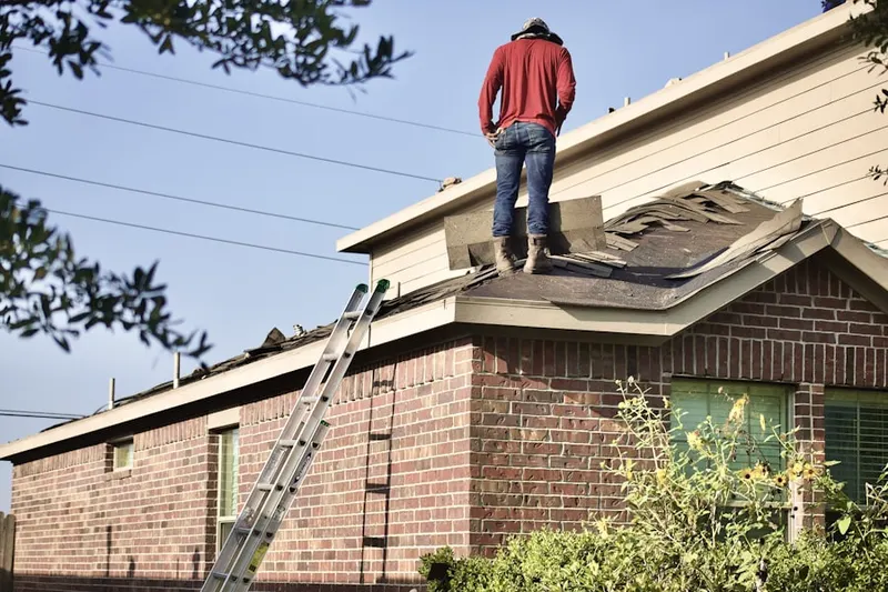 Professional roofer working on a residential roof in Chestnut Pointe